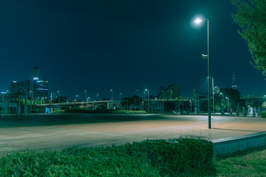 Empty city street at night under moonlight
